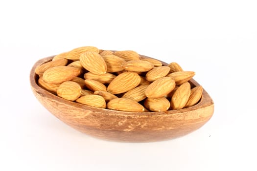 Wood bowl full of almonds, isolated on white
