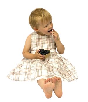 Girl eating blueberries, isolated on white background
