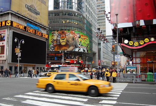 Street view from New York with a yellow cab in motion.