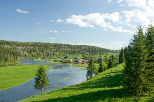 Summer landscape. Village on the river.