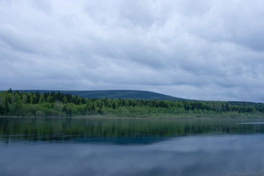 Night summer landscape. Clouds above the river.