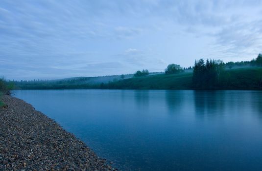 Night summer landscape. Clouds above the river.
