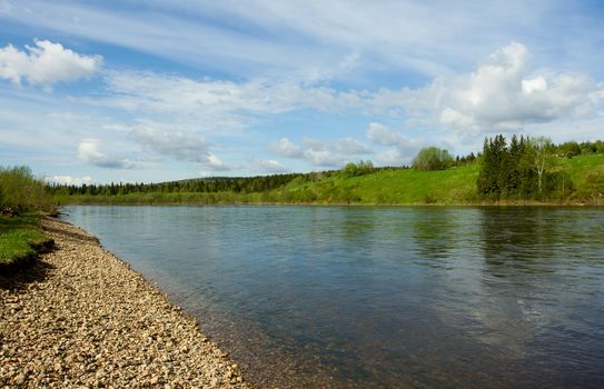 Summer landscape. Clouds above the river.
