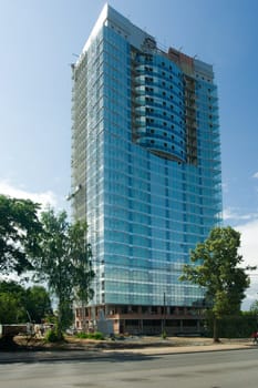 A under construction skyscraper on a background of the sky