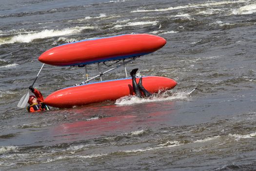 sportsmen and the upturned catamaran in the rapid 
