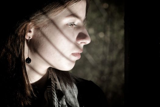 Young scared girl  in old abandoned house.