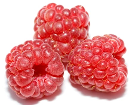 close-up three ripe raspberries, isolated on white