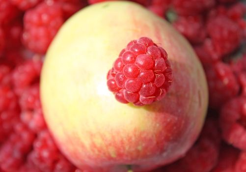 Close up of the juicy raspberry on the apple. 
