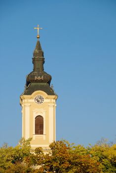 Orthodox Church tower with clock against blue sky - Kikinda, Serbia