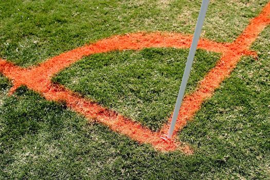 Soccer corner with flag stick on a football field.