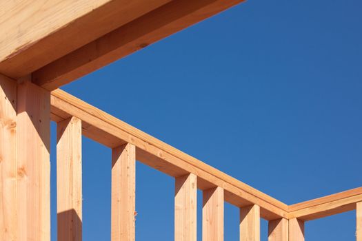 New Residential Home Construction Framing Site Against Blue Sky.