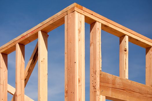 New Residential Home Construction Framing Site Against Blue Sky.