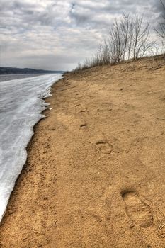 Early spring. Traces on sand along river bank. Russia, the Udmurt republic.
