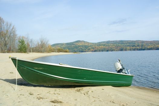 a small green boat near the shore