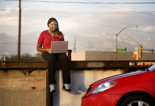 Pretty African American woman with laptop computer