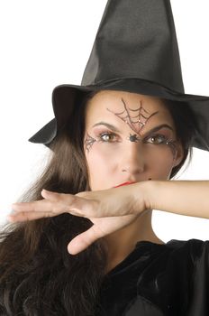 cute girl with witch hat and a spider web painted on face