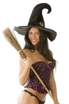 great smile of beautiful sensual brunette with a witch hat and broom