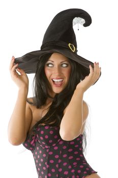 beautiful brunette with blue eyes and witch hat on making face