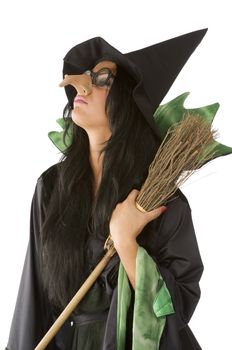 profile of old ugly witch with big nose and glasses arming a broom