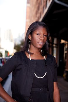 An African American business woman in an urban setting.