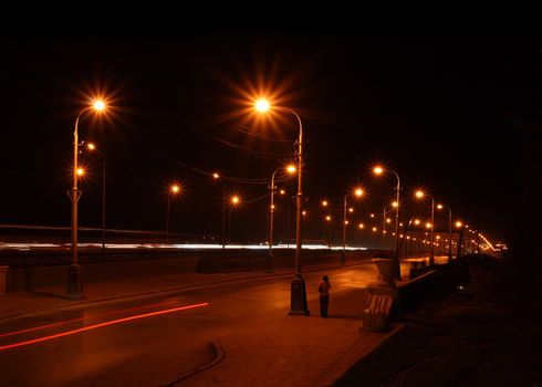 night road through bridge with street lamps