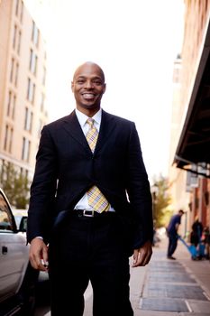 A street portrait of a business man walking on a sidewalk