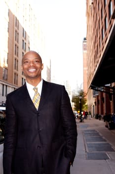 A happy business man on a street in a city