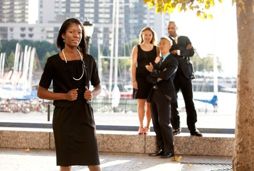 An African American woman in front of a business team