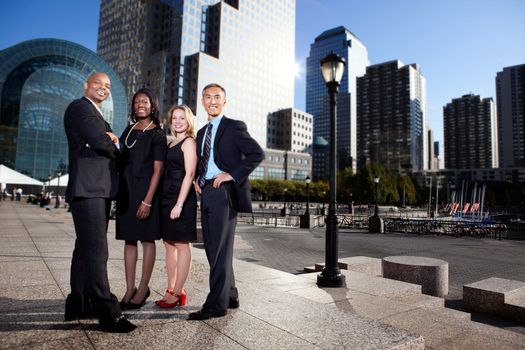 A successful business team in an outdoor setting against a city background