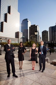A business team portrait with large buildings in the background