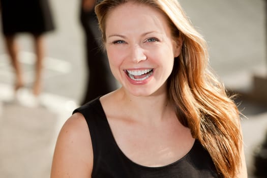 A portrait of a pretty blond woman with black dress