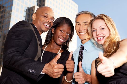 A group of business people giving a thumbs up sign