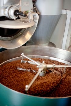 A machine which cools freshly roasted coffee beans.  Shallow depth of field, critical focus on back of beans