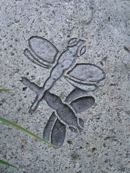 dragonflies sculpted in a rock