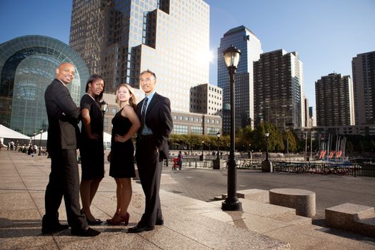 A successful business team in an outdoor setting against a city background