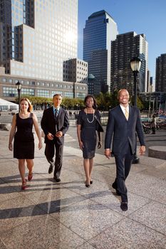 A group of business people walking down town in a large city