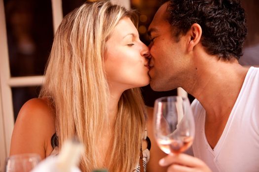 A couple having a romatic meal in an outdoor restaurant