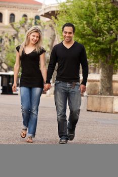 A couple walking outdoors in an urban landscape.