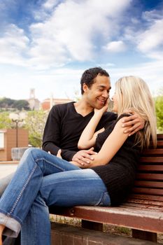 A happy french couple sitting in an urban city park