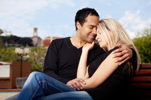 A happy french couple hugging in an urban park