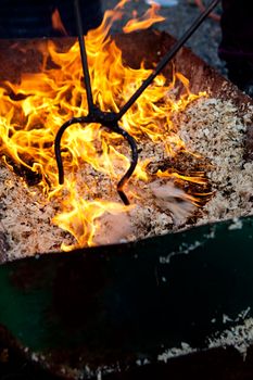 A raku burning pit filled with wood chips