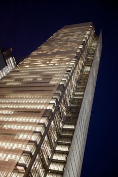 A business building at night with lights on