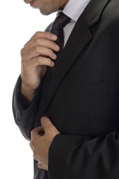 adult man fastening tie with white background