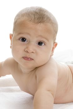 happy child lying and looking at camera on an isolated white background