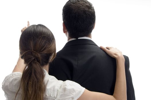 woman pointing towards and posing from back against white background