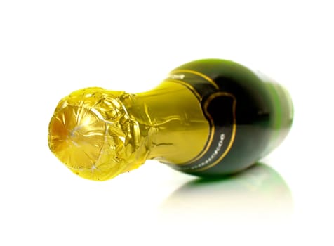 The champagne bottle lays on a white background. Isolation. Shallow DOF