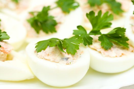 close-up eggs stuffed with red fish, on plate