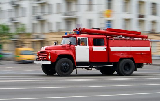 red fire-engine car in motion