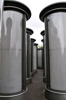 Rows of empty advertising columns stored in a backyard for later installation
