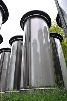Rows of empty advertising columns stored in a backyard for later installation